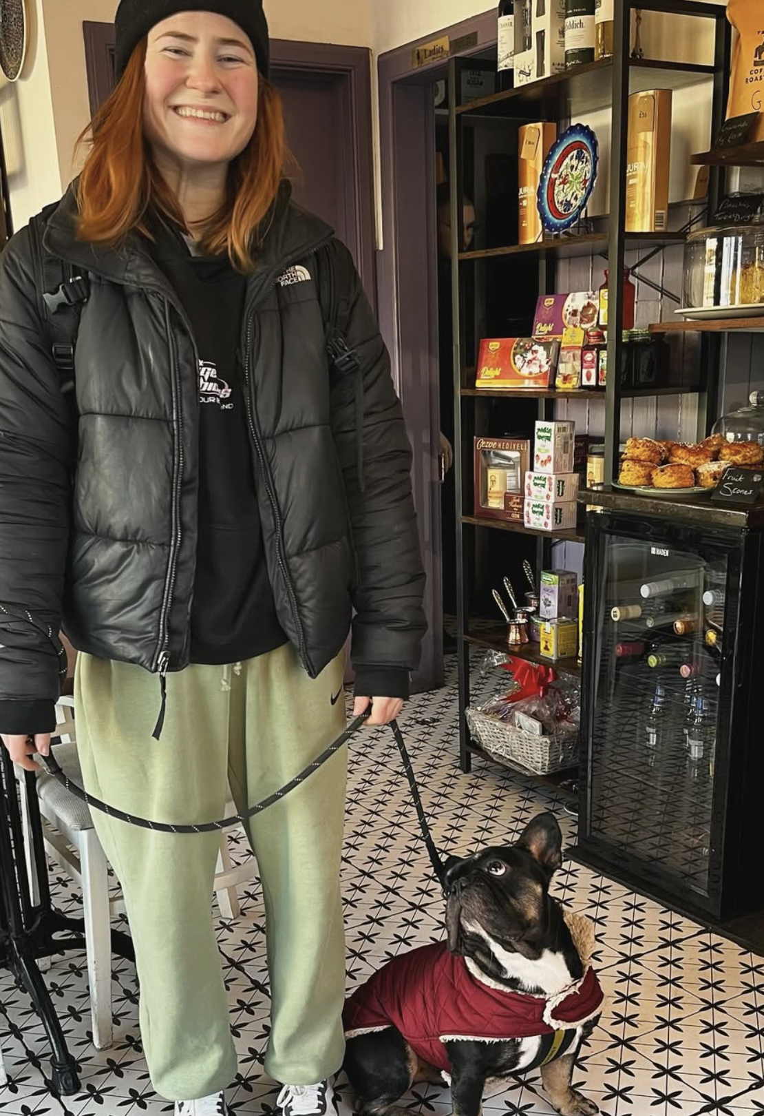 Customer with a French bulldog inside the café