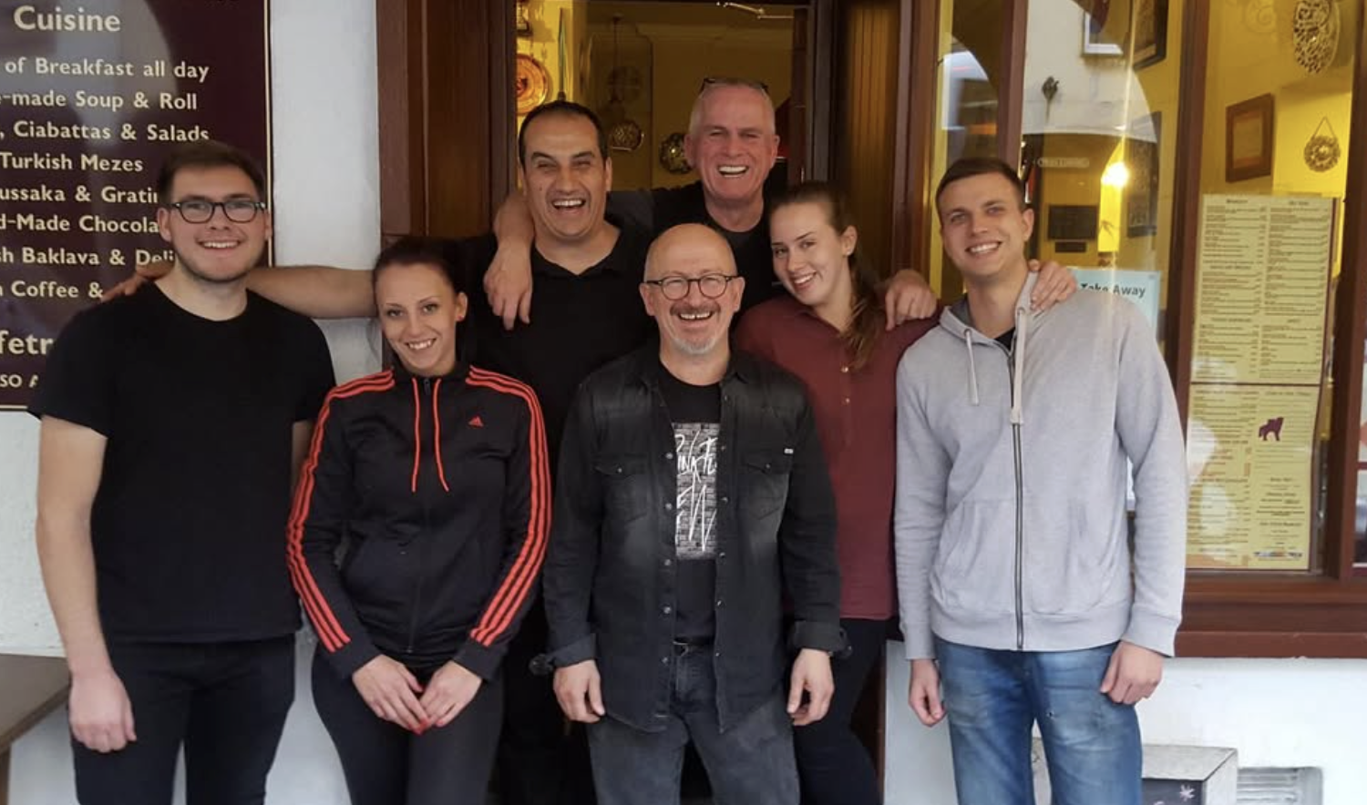 The Café Truva team at the café entrance